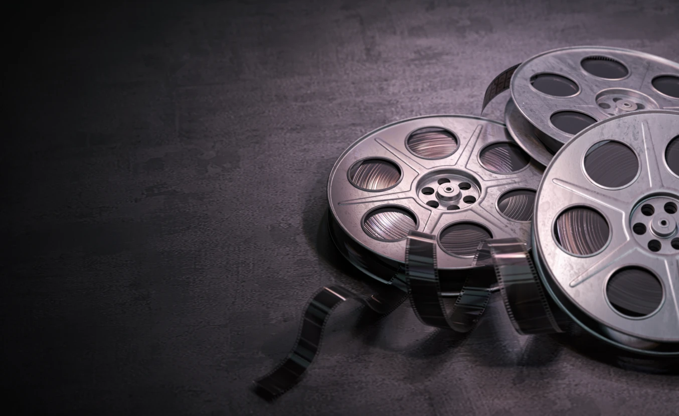 Old cinematic film rolls unraveling