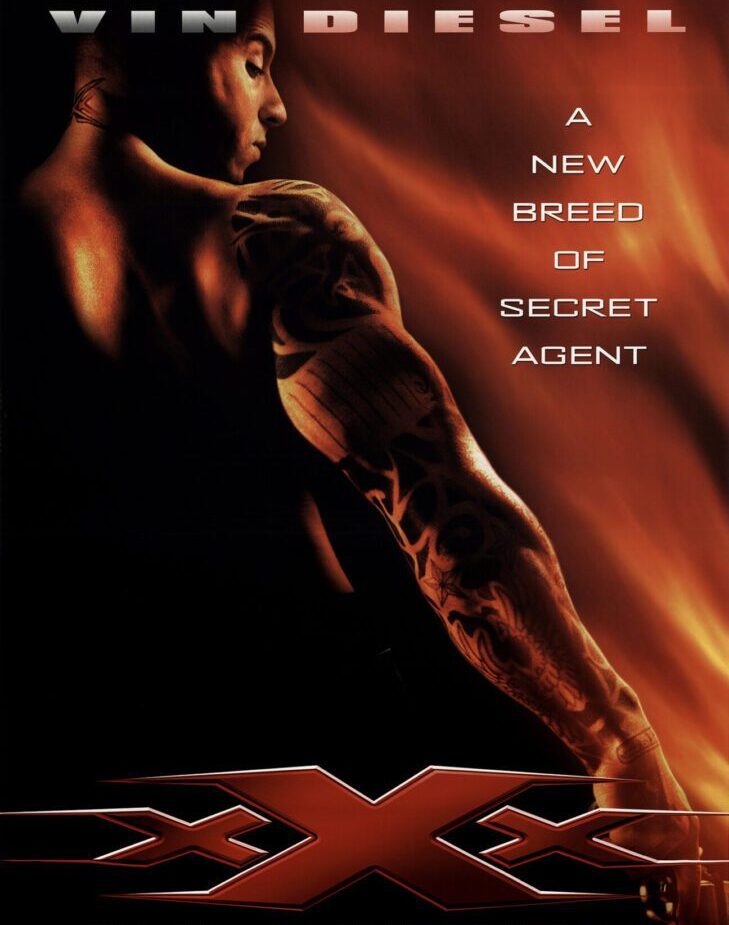 Close-up of a muscular arm with a tattoo, fiery background, and text about a new breed of secret agent.
